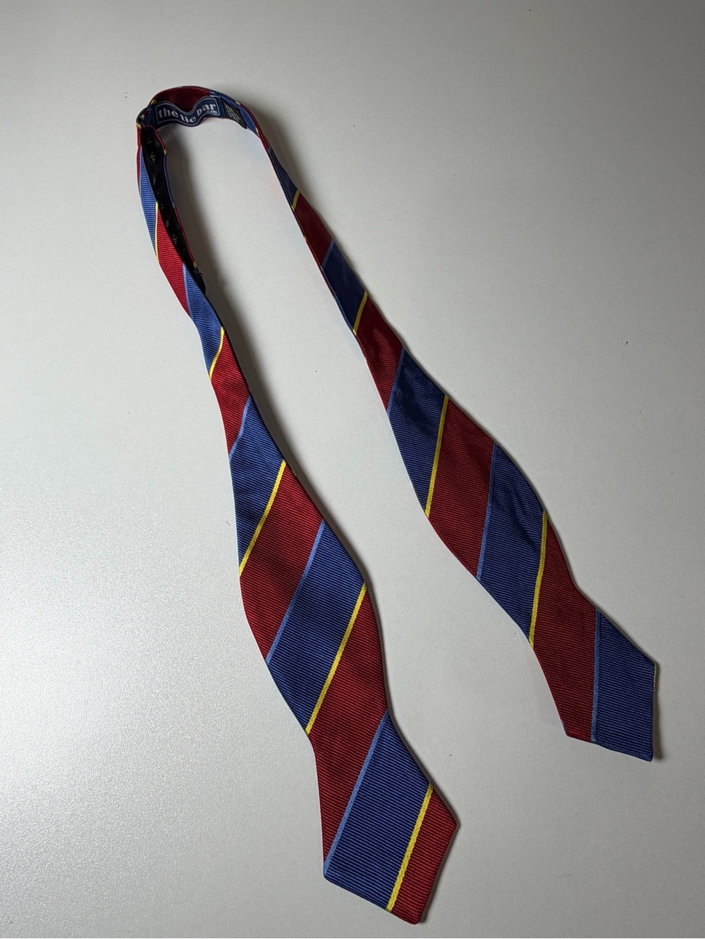 The Tie Bar Red and Blue Striped Adjustable 100% Silk Bow Tie Yellow Accents